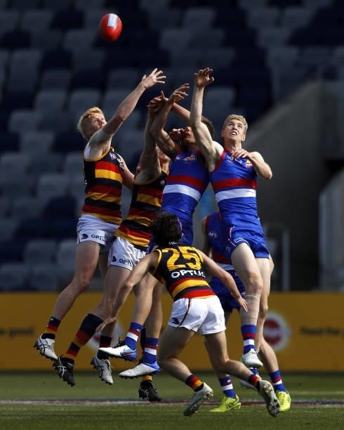 Elliott Himmelberg of the Crows, Reilly OBrien of the Crows, Josh Schache of the Bulldogs and Tim English of the Bulldogs compete for the ball during...