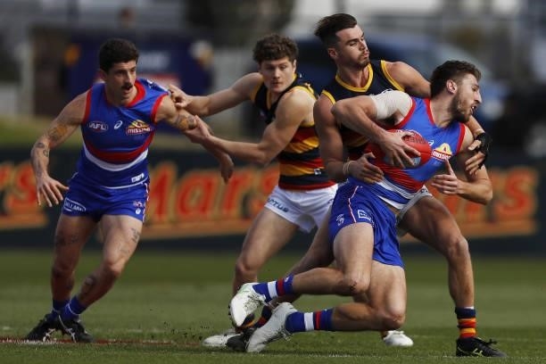 Marcus Bontempelli of the Bulldogs is tackled by Ben Keays of the Crows during the 2021 AFL Round 20 match between the Western Bulldogs and the...