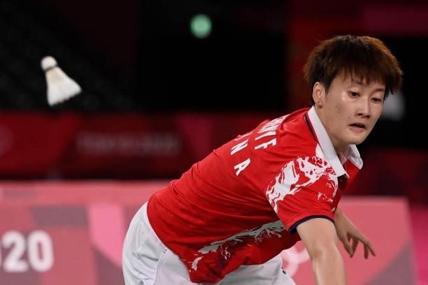 China's Chen Yufei hits a shot to China's He Bingjiao in their women's singles badminton semi-final match during the Tokyo 2020 Olympic Games at the...
