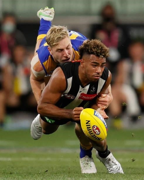 Isaac Quaynor of the Magpies is tackled by Oscar Allen of the Eagles during the 2021 AFL Round 20 match between the Collingwood Magpies and the West...