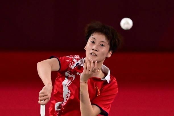 China's Chen Yufei hits a shot to China's He Bingjiao in their women's singles badminton semi-final match during the Tokyo 2020 Olympic Games at the...