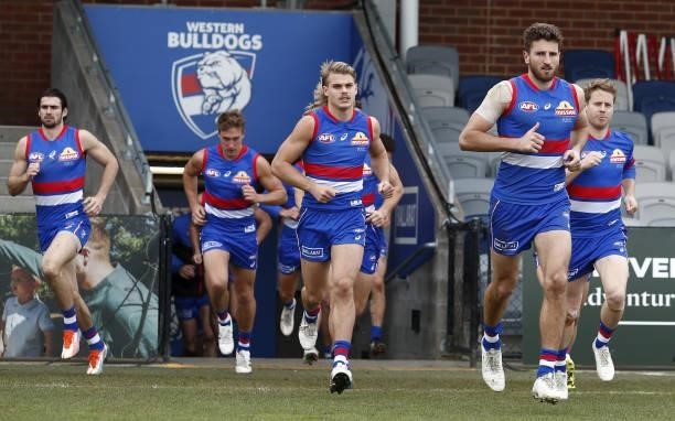 Marcus Bontempelli of the Bulldogs leads his team on to the field during the 2021 AFL Round 20 match between the Western Bulldogs and the Adelaide...