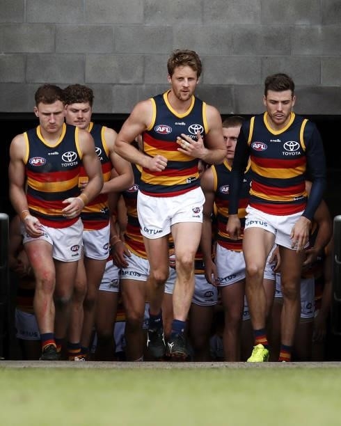 Rory Sloane of the Crows, Rory Laird of the Crows and Paul Seedsman of the Crows run on to the ground during the 2021 AFL Round 20 match between the...