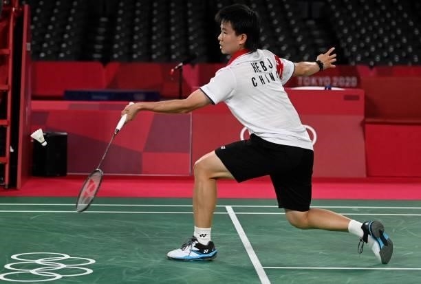 China's He Bingjiao hits a shot to China's Chen Yufei in their women's singles badminton semi-final match during the Tokyo 2020 Olympic Games at the...