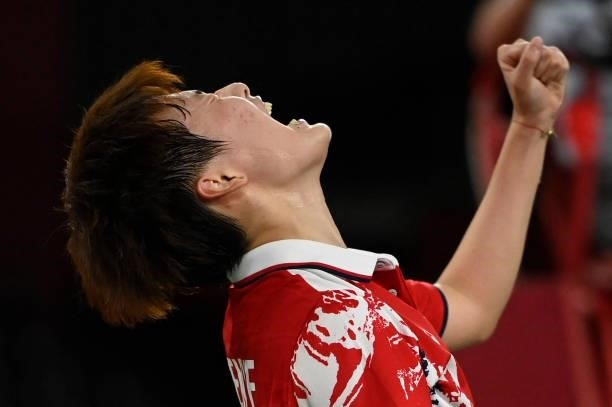 China's Chen Yufei celebrates beating China's He Bingjiao in their women's singles badminton semi-final match during the Tokyo 2020 Olympic Games at...