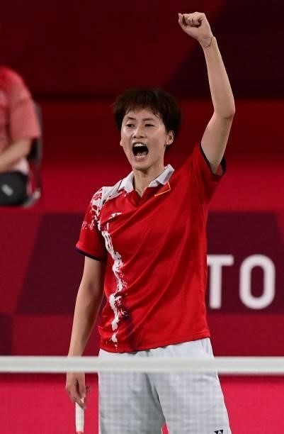 China's Chen Yufei celebrates beating China's He Bingjiao in their women's singles badminton semi-final match during the Tokyo 2020 Olympic Games at...