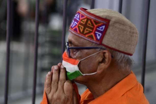 Man wearing a face mask in the colours of the Indian national flag watches India's P. V. Sindhu play Taiwan's Tai Tzu-ying in their women's singles...