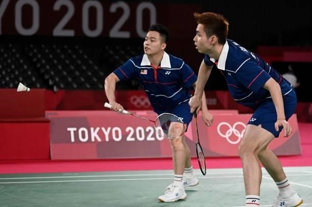 Malaysia's Soh Wooi Yik and Malaysia's Aaron Chia prepare for a shot during a rally in their men's doubles badminton bronze medal match against...