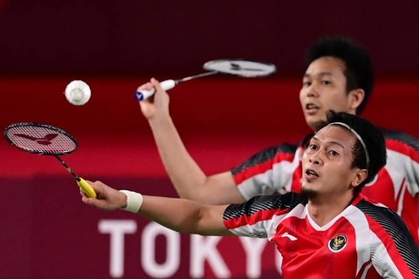 Indonesia's Hendra Setiawan prepares to hit a shot next to Indonesia's Mohammad Ahsan in their men's doubles badminton bronze medal match against...