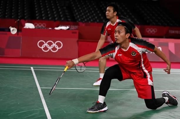 Indonesia's Mohammad Ahsan hits a shot next to Indonesia's Hendra Setiawan in their men's doubles badminton bronze medal match against Malaysia's...
