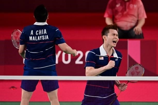 Malaysia's Soh Wooi Yik and Malaysia's Aaron Chia react as they win their men's doubles badminton bronze medal match against Indonesia's Mohammad...