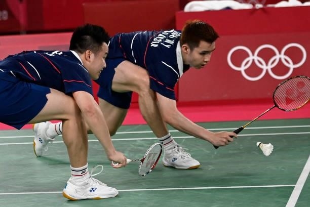 Malaysia's Soh Wooi Yik and Malaysia's Aaron Chia watch the shuttlecock during a rally in their men's doubles badminton bronze medal match against...