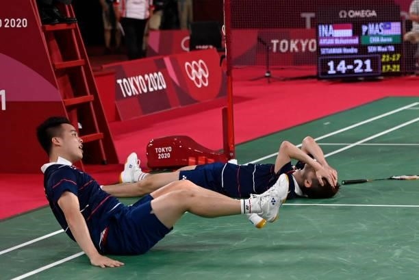 Malaysia's Soh Wooi Yik and Malaysia's Aaron Chia celebrate as they win their men's doubles badminton bronze medal match against Indonesia's Mohammad...