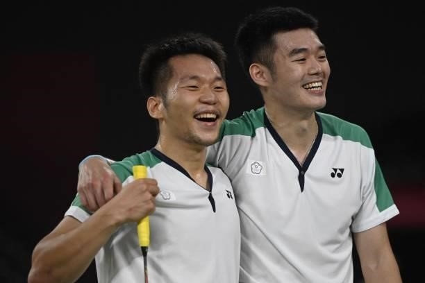 Taiwan's Lee Yang and Taiwan's Wang Chi-lin celebrate winning their men's doubles badminton final match against China's Li Junhui and China's Liu...