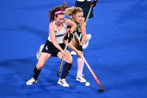 Britain's Laura Unsworth and Ireland's Chloe Watkins vie for the ball during their women's pool A match of the Tokyo 2020 Olympic Games field hockey...