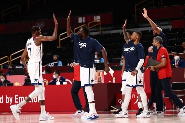 Kevin Durant of the USA Men's National Team high fives Draymond Green of the USA Men's National Team during the 2020 Tokyo Olympics on July 31, 2021...