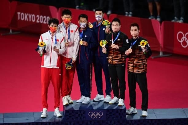 Taiwan's Lee Yang and Taiwan's Wang Chi-lin pose with their men's doubles badminton gold medals next to China's Liu Yuchen and China's Li Junhui with...