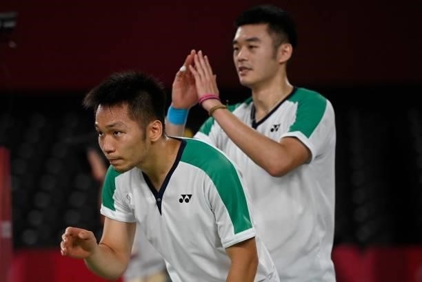 Taiwan's Lee Yang and Taiwan's Wang Chi-lin celebrate winning their men's doubles badminton final match against China's Li Junhui and China's Liu...