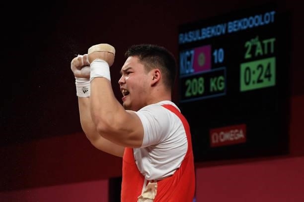 Kyrgyzstan's Bekdoolot Rasulbekov gestures as he competes in the men's 96kg weightlifting competition during the Tokyo 2020 Olympic Games at the...