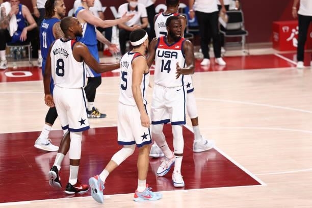 Draymond Green hi-fives Khris Middleton and Devin Booker of the USA Men's National Team during the game against the Czech Republic Men's National...
