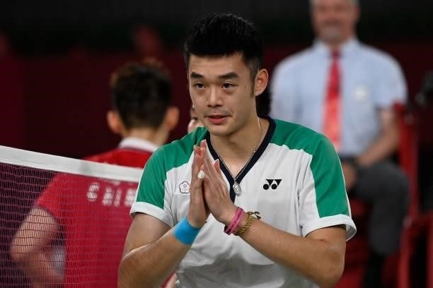 Taiwan's Wang Chi-lin celebrates winning his men's doubles badminton final match with Taiwan's Lee Yang against China's Li Junhui and China's Liu...