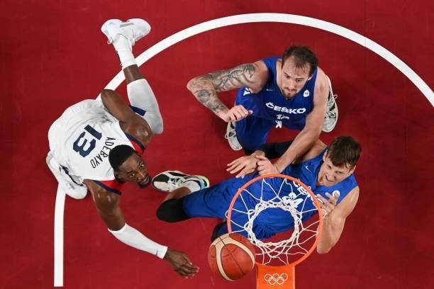 S Edrice Femi Adebayo and Czech Republic's Ondrej Balvin and Jan Vesely fight for the ball in the men's preliminary round group A basketball match...