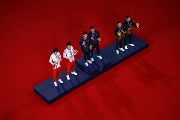 Taiwan's Lee Yang and Taiwan's Wang Chi-lin pose with their men's doubles badminton gold medals next to China's Liu Yuchen and China's Li Junhui with...