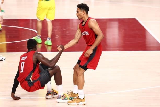 Maodo Lo helps up Isaac Bonga of the Germany Men's National Team during the game against the Australia Men's National Team during the 2020 Tokyo...