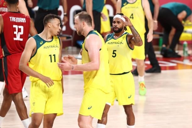 Dante Exum talks with Patty Mills and Joe Ingles of the Australia Men's National Team during the game against the Germany Men's National Team during...
