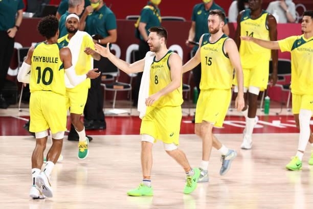 Matisse Thybulle hi-fives Patty Mills and Matthew Dellavedova of the Australia Men's National Team during the game against the Germany Men's National...