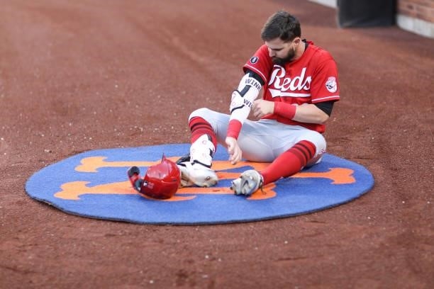 Jesse Winker of the Cincinnati Reds puts on his equipment before the game between the Cincinnati Reds and the New York Mets at Citi Field on Friday,...