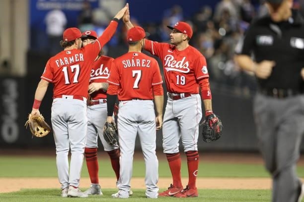 The Cincinnati Reds celebrate after winning the game between the Cincinnati Reds and the New York Mets at Citi Field on Friday, July 30, 2021 in New...
