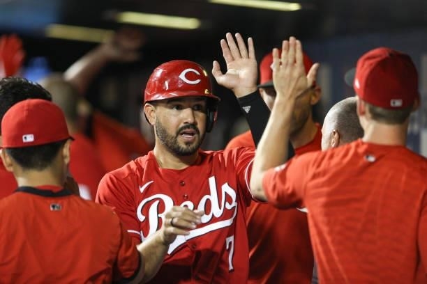 Eugenio Suárez of the Cincinnati Reds celebrates in the dugout during the game between the Cincinnati Reds and the New York Mets at Citi Field on...