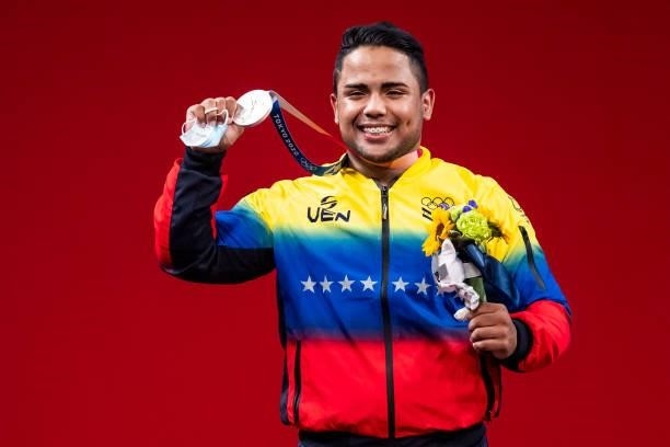 Keydomar Giovan Vallenilla Sanchez of Venezuela cheers at the award ceremony in the Men's 96kg Group B weightlifting competition on day eight of the...