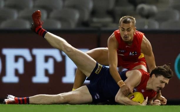 Jake Lever of the Demons and Joel Jeffrey of the Suns compete for the ball during the 2021 AFL Round 20 match between the Gold Coast Suns and the...