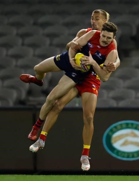 Jake Lever of the Demons and Joel Jeffrey of the Suns compete for the ball during the 2021 AFL Round 20 match between the Gold Coast Suns and the...