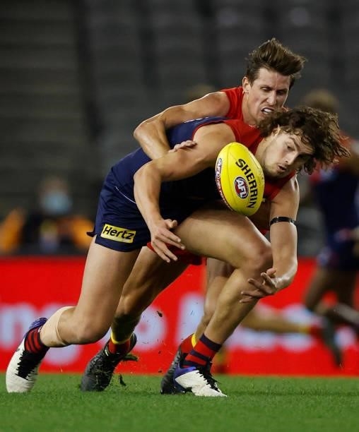 Luke Jackson of the Demons is tackled by David Swallow of the Suns during the 2021 AFL Round 20 match between the Gold Coast Suns and the Melbourne...