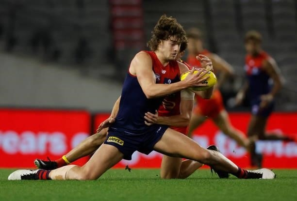 Luke Jackson of the Demons is tackled by David Swallow of the Suns during the 2021 AFL Round 20 match between the Gold Coast Suns and the Melbourne...