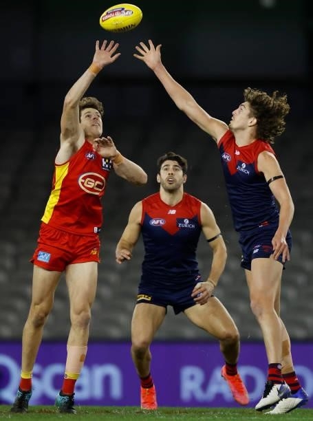 Chris Burgess of the Suns and Luke Jackson of the Demons in action during the 2021 AFL Round 20 match between the Gold Coast Suns and the Melbourne...