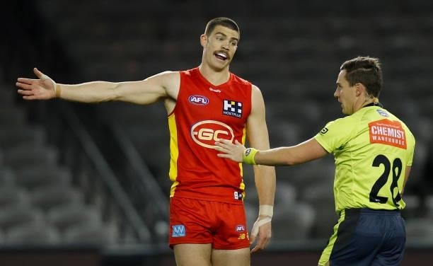 Sam Collins of the Suns speaks with AFL Field Umpire, Cameron Dore during the 2021 AFL Round 20 match between the Gold Coast Suns and the Melbourne...