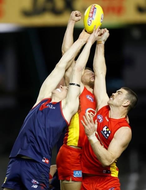 Ben Brown of the Demons, Jy Farrar of the Suns and Sam Collins of the Suns compete for the ball during the 2021 AFL Round 20 match between the Gold...