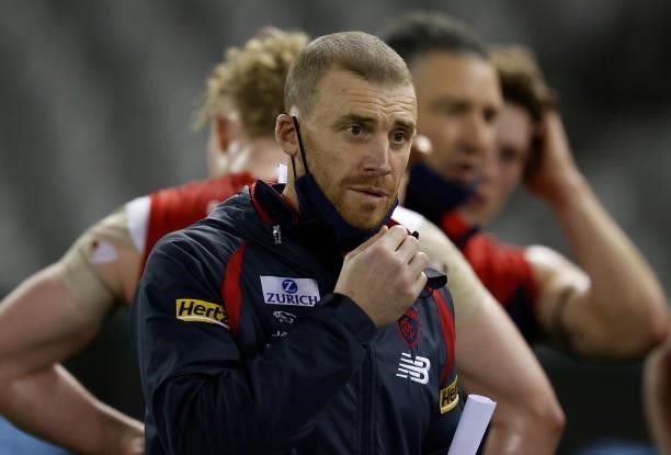 Simon Goodwin, Senior Coach of the Demons looks on during the 2021 AFL Round 20 match between the Gold Coast Suns and the Melbourne Demons at Marvel...