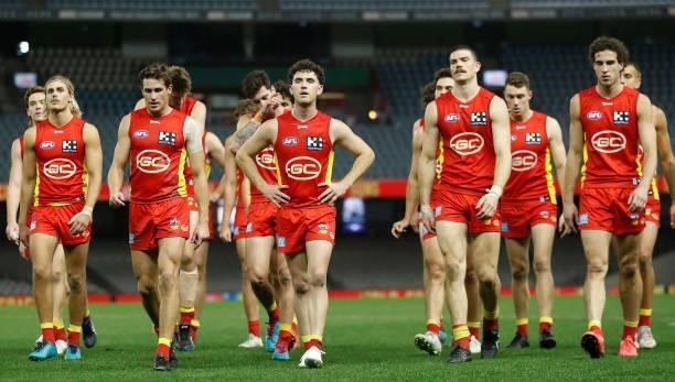 The Suns look dejected after a loss during the 2021 AFL Round 20 match between the Gold Coast Suns and the Melbourne Demons at Marvel Stadium on...