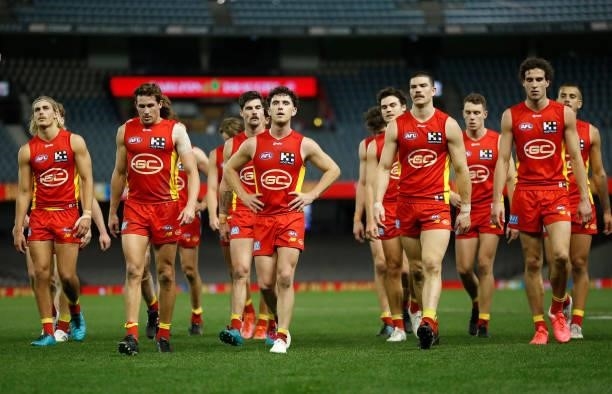 The Suns look dejected after a loss during the 2021 AFL Round 20 match between the Gold Coast Suns and the Melbourne Demons at Marvel Stadium on...