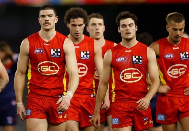 Sam Collins and Jack Bowes of the Suns look dejected after a loss during the 2021 AFL Round 20 match between the Gold Coast Suns and the Melbourne...