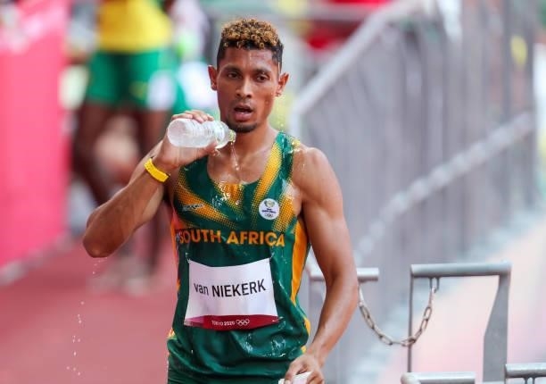 Wayde van Niekerk of South Africa, World and Olympic record holder in the mens 400m, pours cold water on his head after he ran in the heats in the...