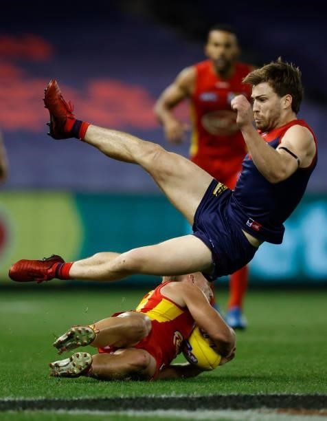 Jack Viney of the Demons and Darcy MacPherson of the Suns collide during the 2021 AFL Round 20 match between the Gold Coast Suns and the Melbourne...