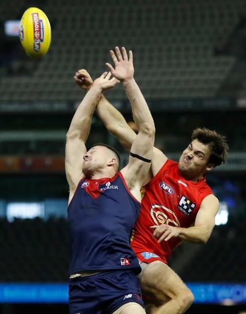 Steven May of the Demons and Jack Bowes of the Suns compete for the ball during the 2021 AFL Round 20 match between the Gold Coast Suns and the...
