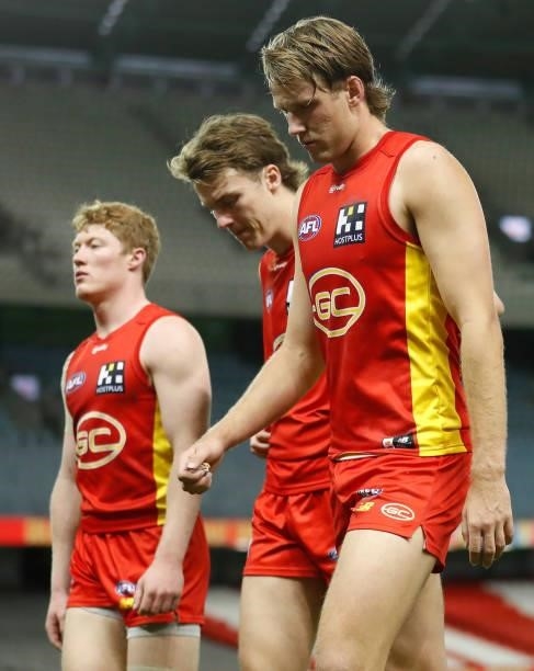 Matt Rowell, Charlie Ballard and Jack Lukosius of the Suns look dejected after a loss during the 2021 AFL Round 20 match between the Gold Coast Suns...
