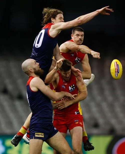 Max Gawn of the Demons, Ben Brown of the Demons, Zac Smith of the Suns and Sam Collins of the Suns compete for the ball during the 2021 AFL Round 20...